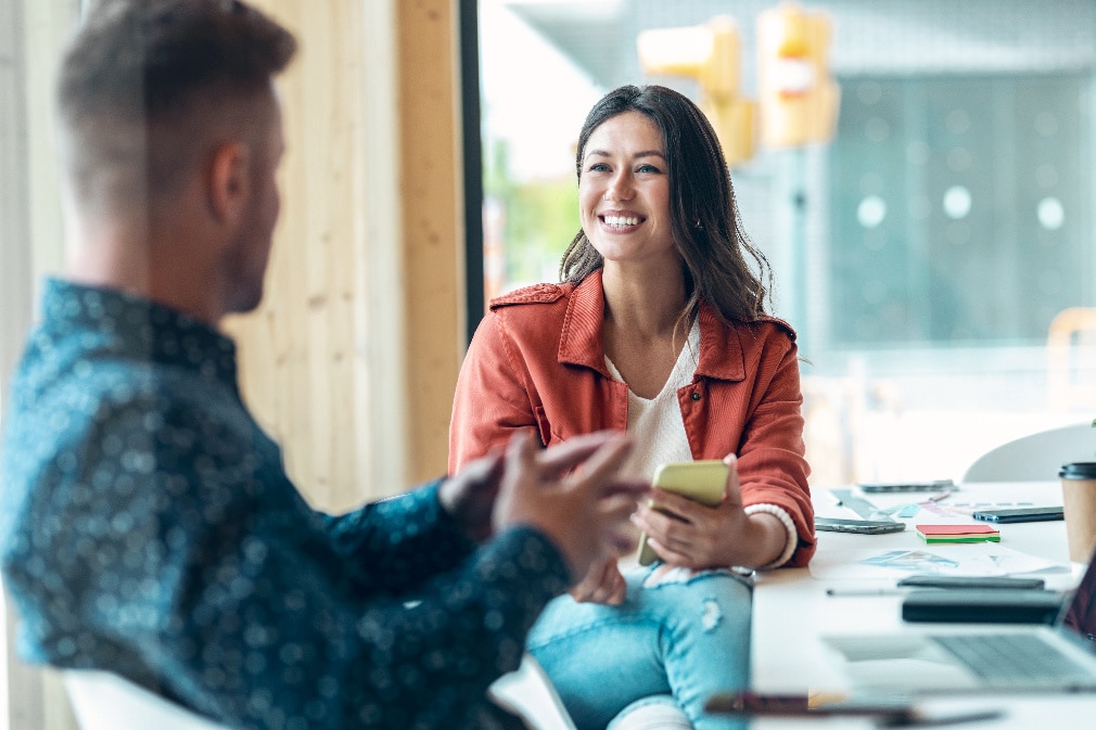 Healthcare working showing a tablet to woman in wheelchair