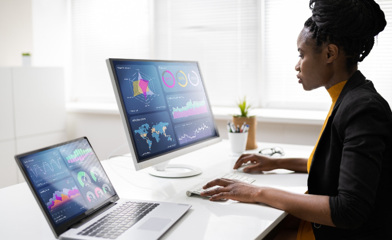 Person working in front of two computer monitors
