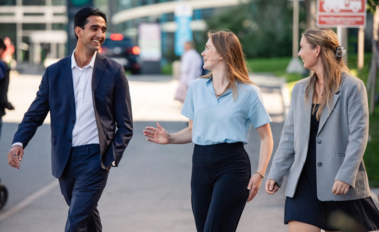 Three colleagues walking in the city