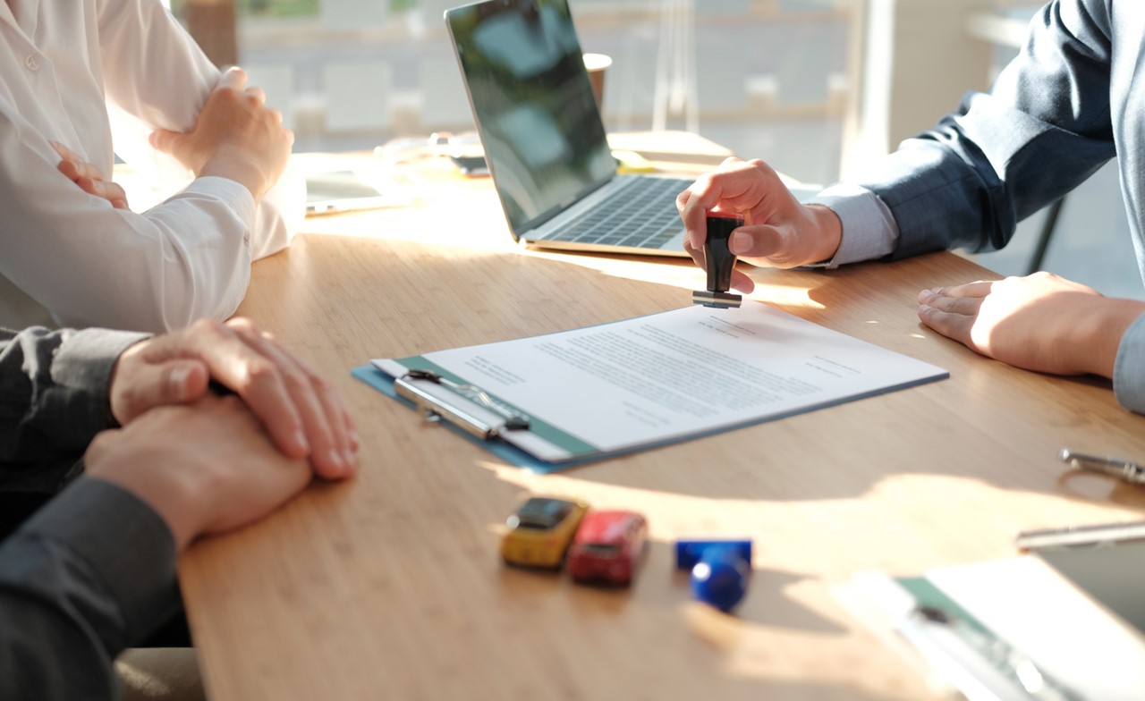 Professionals around desk reviewing document