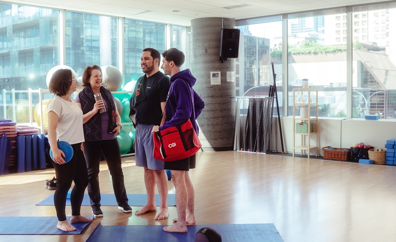 Group of people talking in a fitness room