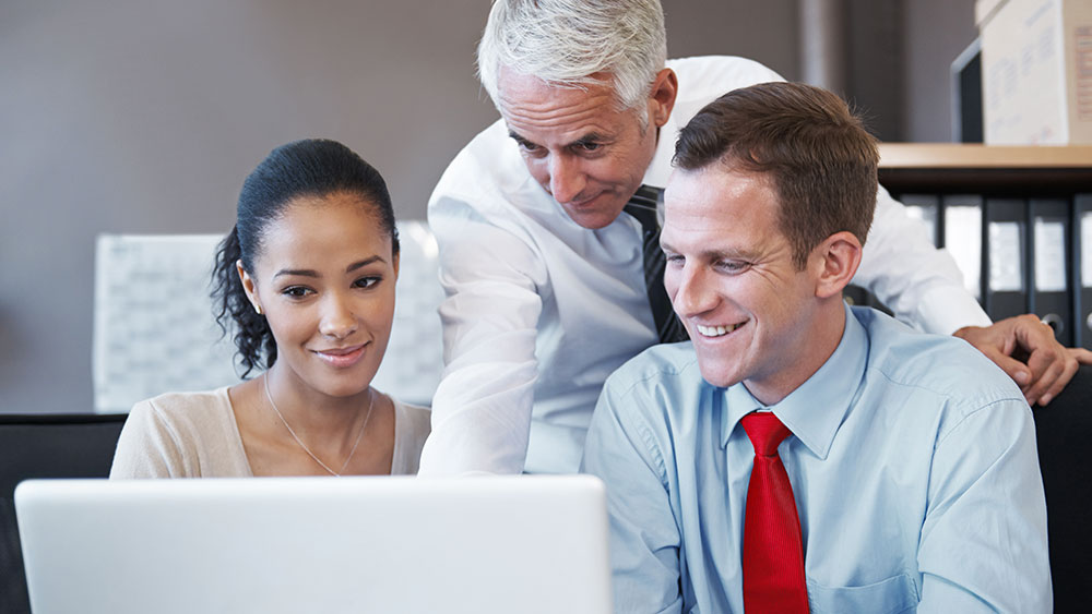 insurance ratabase group working smiling laptop