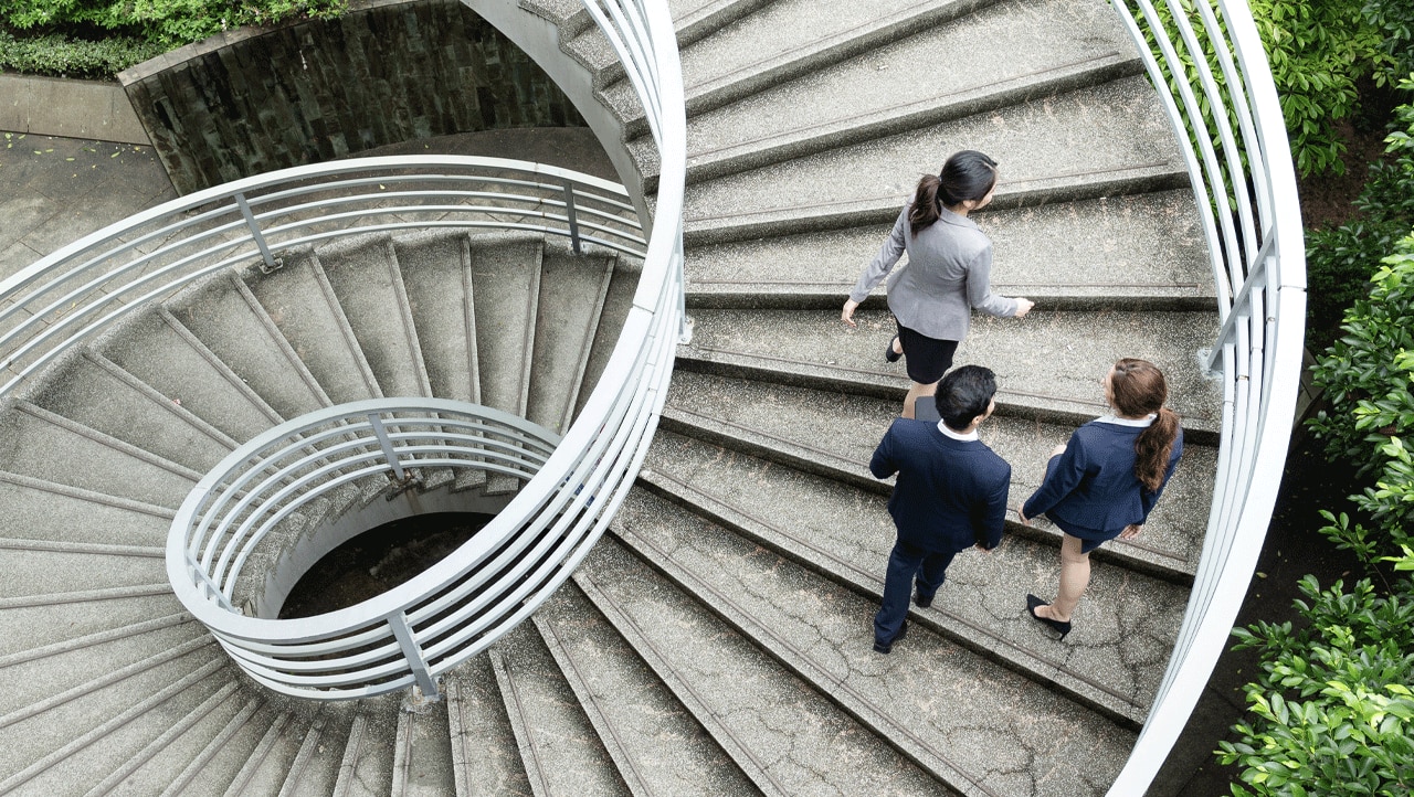 Managed IT services consultants on a large modern spiral staircase