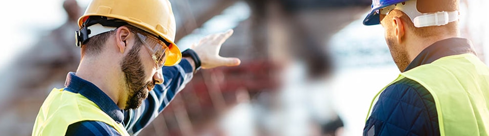 Workers looking at stats and diagrams on clipboard