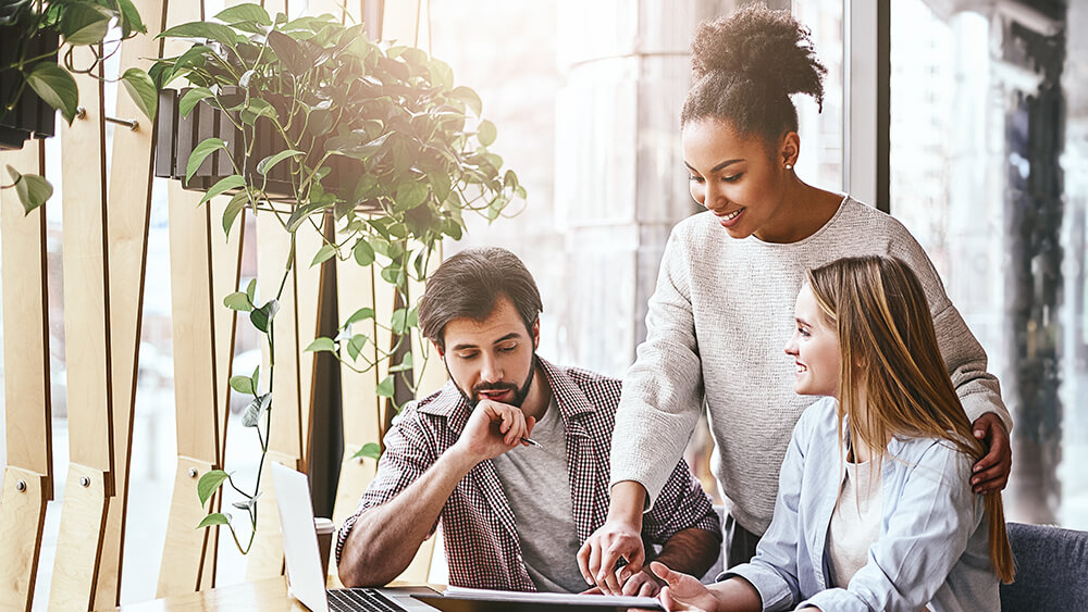 three people working together