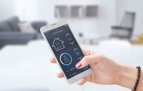 A woman uses smartphone to control utilities, representing CGI’s work with GRDF