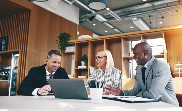 three consultants working at a table