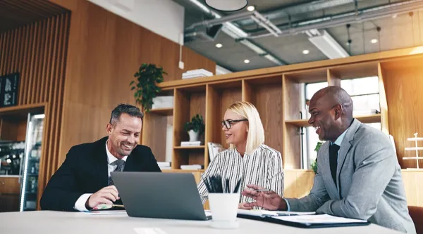 three consultants working at a table