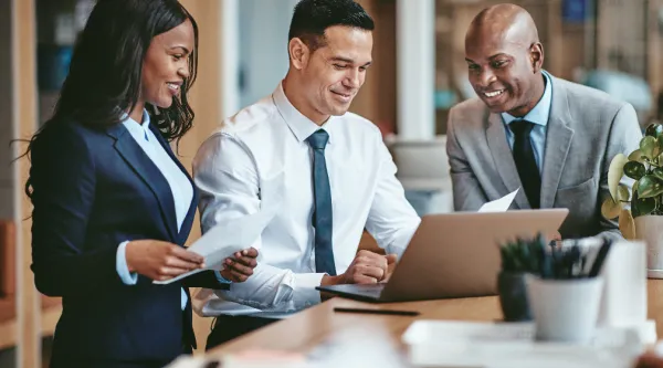 professionals collaborating at a laptop