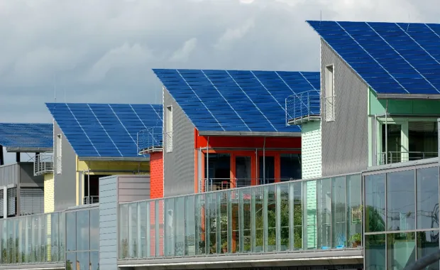 Modern homes with solar panel rooftops in a sustainable housing development