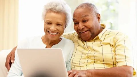 Elderly couple using laptop