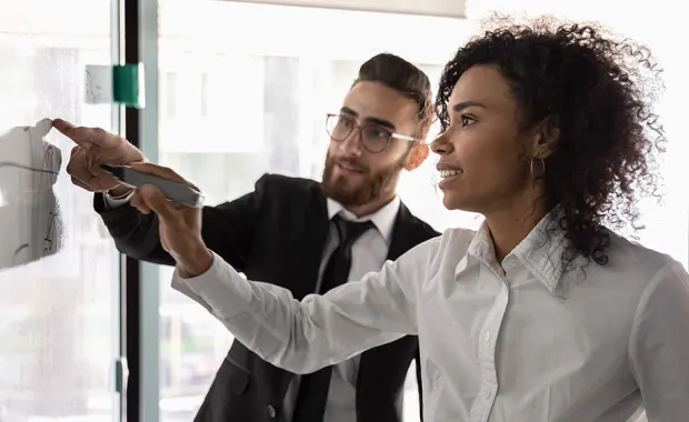 colleagues writing on a whiteboard