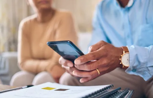 Diverse man and woman looking at phone