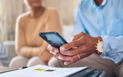 Diverse man and woman looking at phone