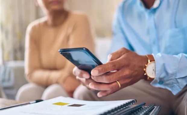 Diverse man and woman looking at phone