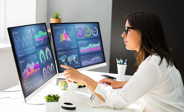 Consultant analyzing data on a desktop computer