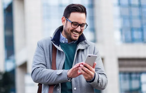 man smiling looking at the phone