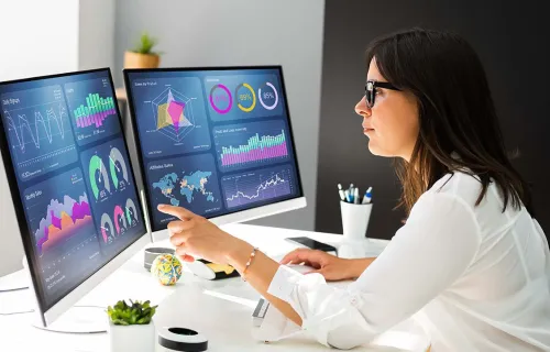 Consultant analyzing data on a desktop computer