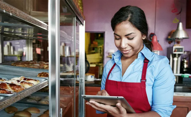 Woman holding a tablet and looking at goods