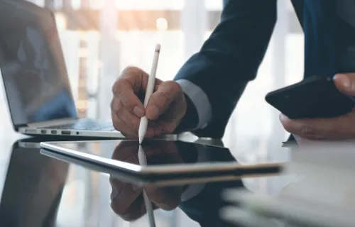 Person signing electronic signature on a tablet