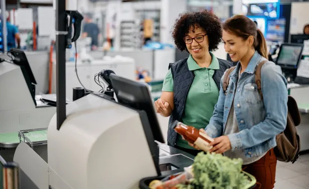 Super market employee helps customer