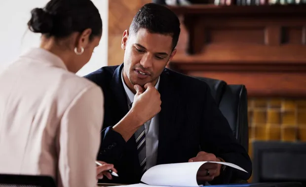 Two colleagues overlooking a document