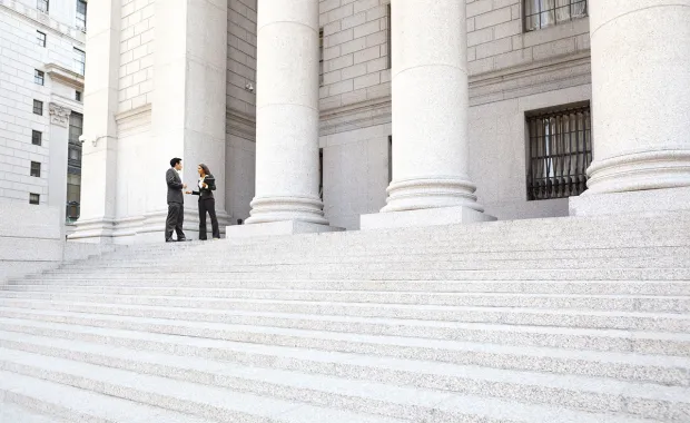 two professionals on steps of building